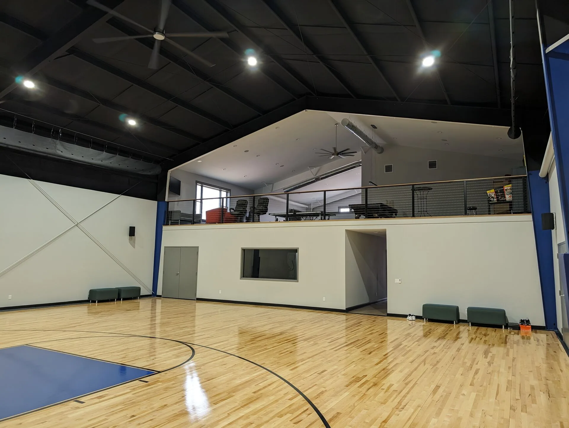 Private residential amenity wing by Harber Built — full indoor basketball court